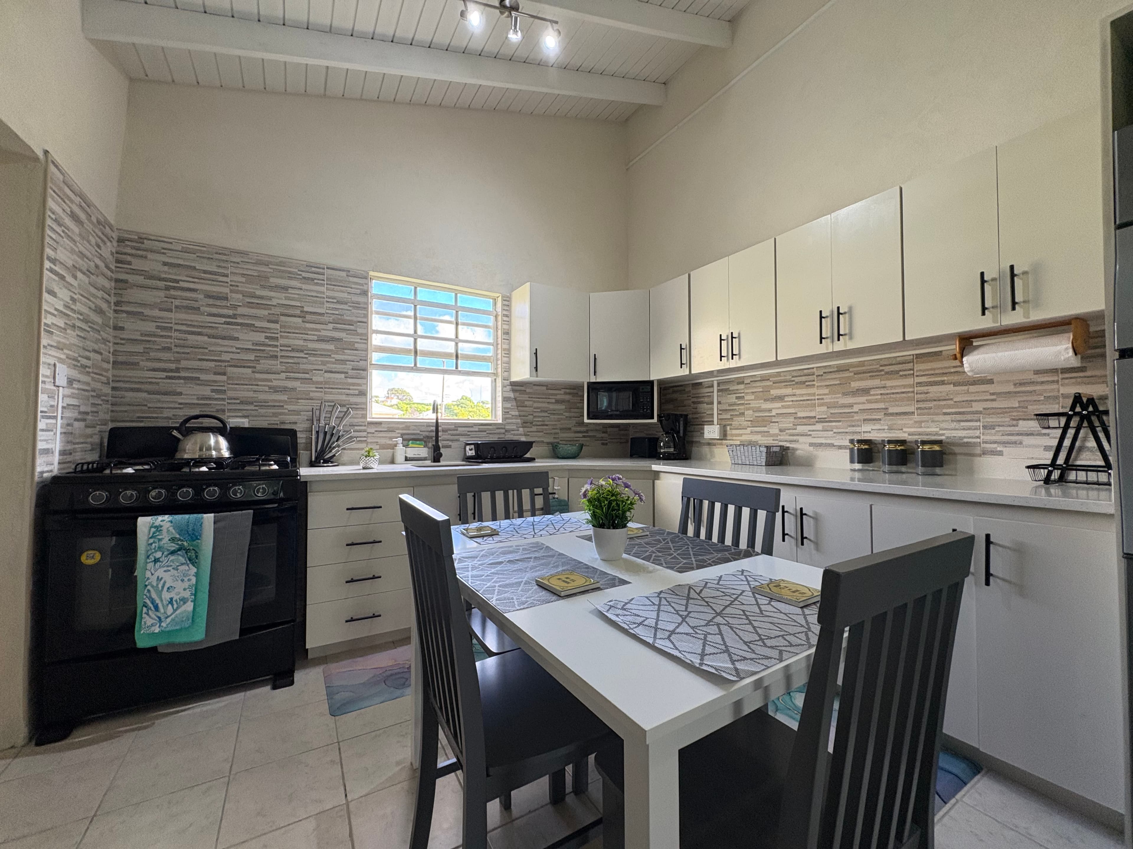 Bright kitchen and dining area inside the Balcony Suite.